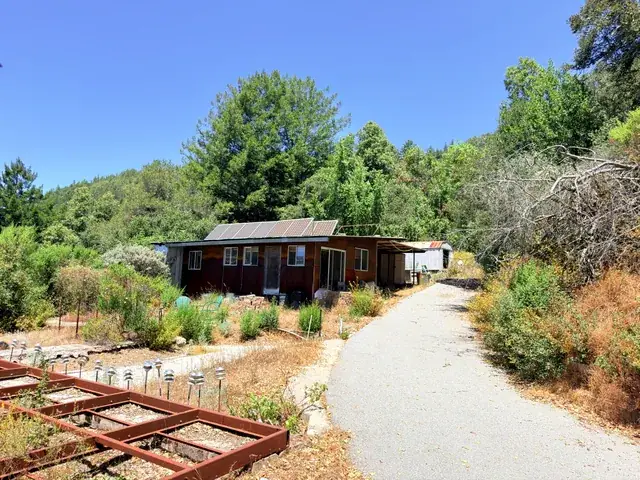 Steel frame set on a graded pad with canyon views